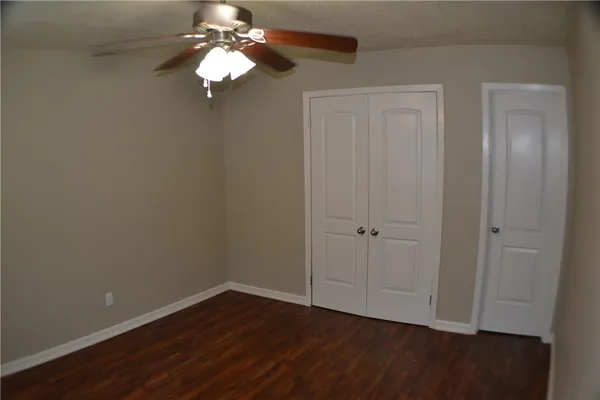 a view of a chandelier fan and hardwood floor