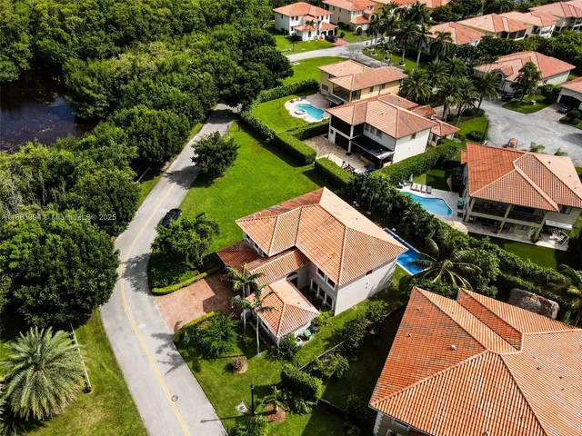 an aerial view of a house with a yard