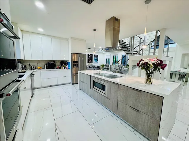 a kitchen with stainless steel appliances granite countertop a sink and a stove