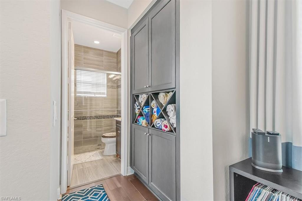 4616 Azalea Drive Naples, FL 34119 - Photo 10 of 44 Full bathroom with a shower stall, light wood finished floors, and vanity