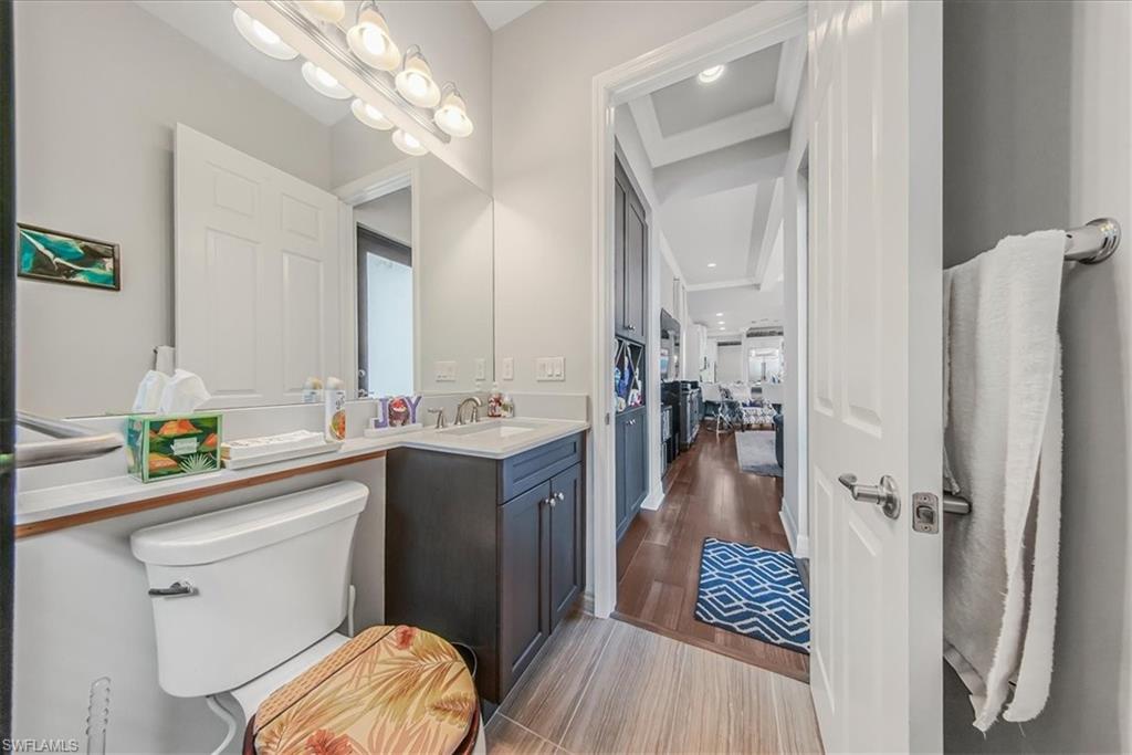 4616 Azalea Drive Naples, FL 34119 - Photo 11 of 44 Half bathroom with light wood-style flooring, vanity, and recessed lighting