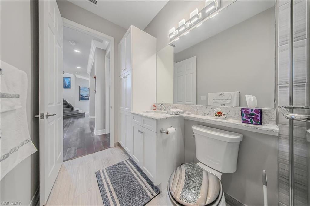 4616 Azalea Drive Naples, FL 34119 - Photo 13 of 44 Half bathroom featuring vanity and light wood-style floors
