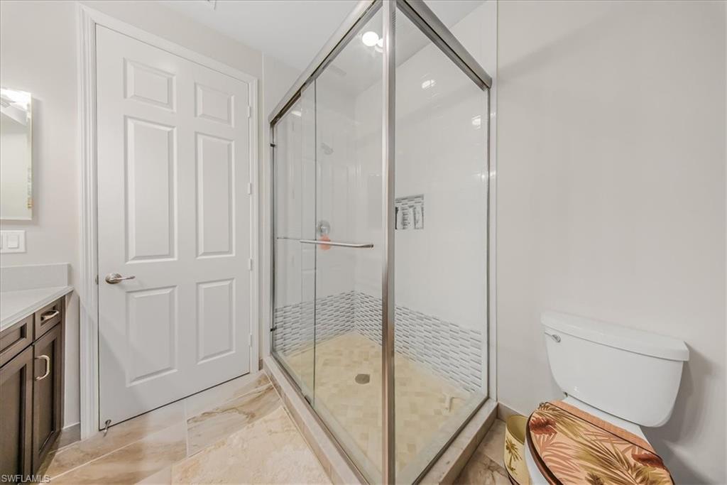 4616 Azalea Drive Naples, FL 34119 - Photo 16 of 44 Full bathroom featuring vanity and a shower stall