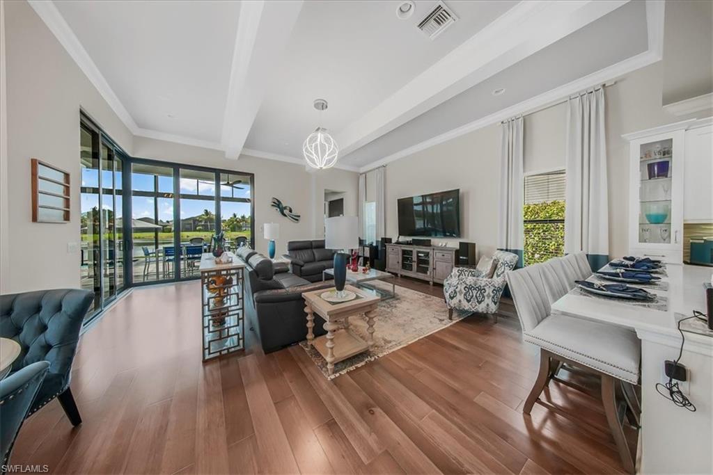 4616 Azalea Drive Naples, FL 34119 - Photo 25 of 44 Living area with crown molding, beamed ceiling, and dark wood finished floors