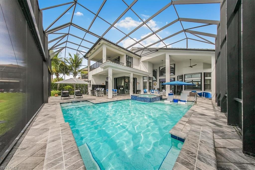 4616 Azalea Drive Naples, FL 34119 - Photo 29 of 44 View of swimming pool featuring ceiling fan, a patio, a sunroom, and a pool with connected hot tub