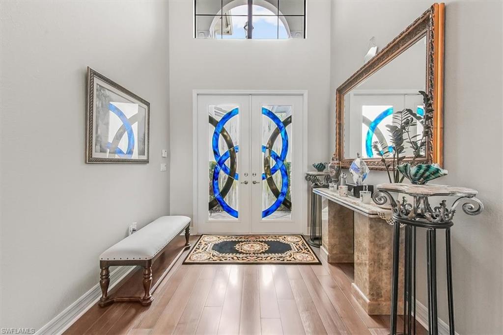 4616 Azalea Drive Naples, FL 34119 - Photo 3 of 44 Foyer with french doors and wood finished floors