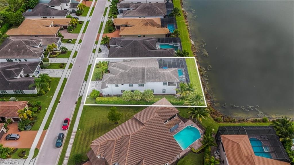 4616 Azalea Drive Naples, FL 34119 - Photo 34 of 44 Aerial view of residential area with a pool and a large body of water