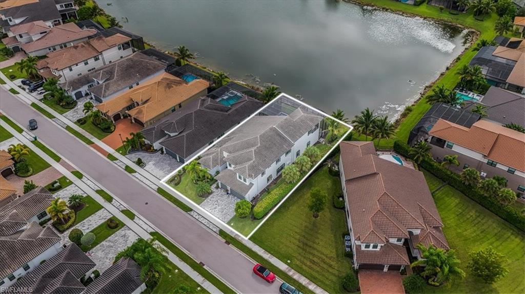 4616 Azalea Drive Naples, FL 34119 - Photo 36 of 44 Aerial perspective of suburban area featuring a large body of water and property parcel outlined