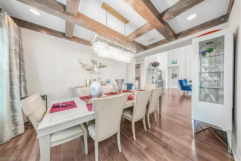 4616 Azalea Drive Naples, FL 34119 - Photo 6 of 44 Dining space featuring beam ceiling, light wood-style flooring, coffered ceiling, and a chandelier