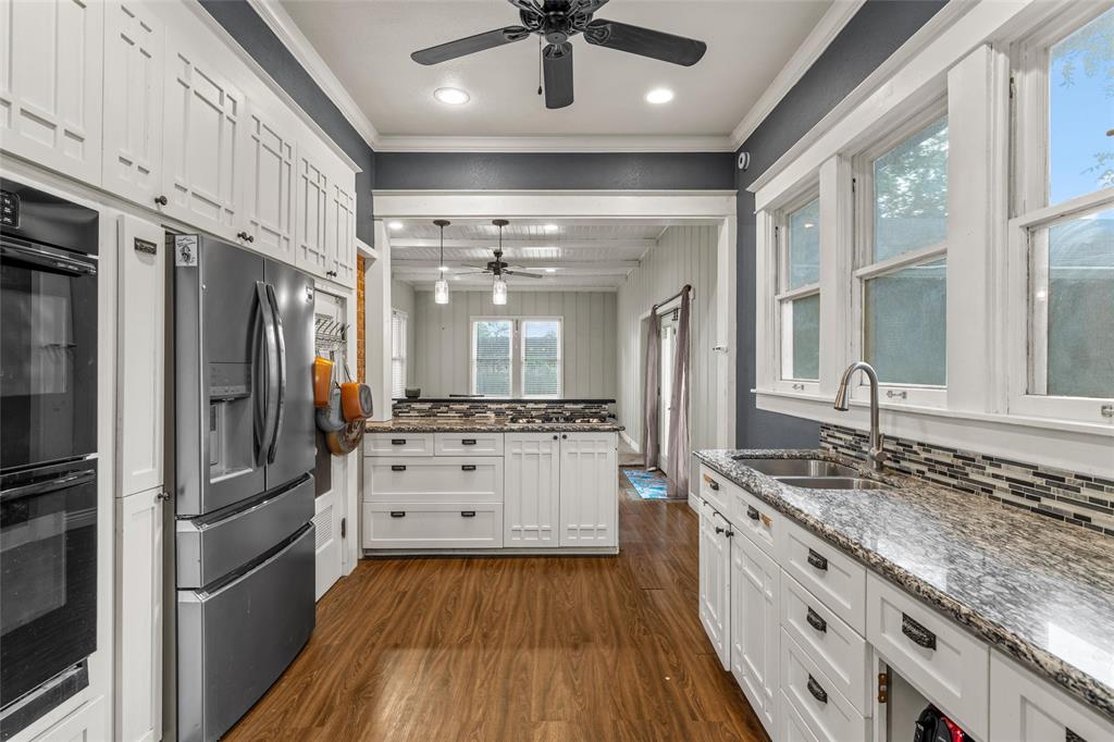 2717 Colcord Avenue Waco, TX 76707 - Photo 6 of 34 a kitchen with stainless steel appliances granite countertop a stove refrigerator and cabinets