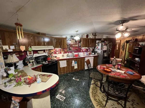 a kitchen with a sink a stove and chairs