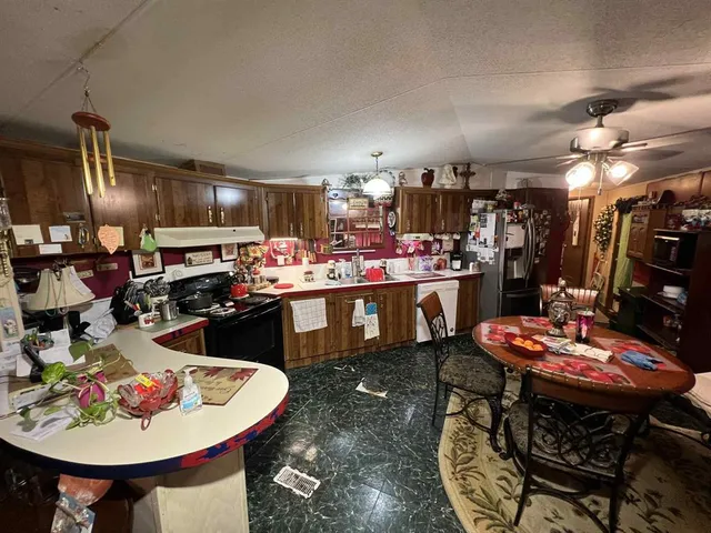 a kitchen with a sink a stove and chairs