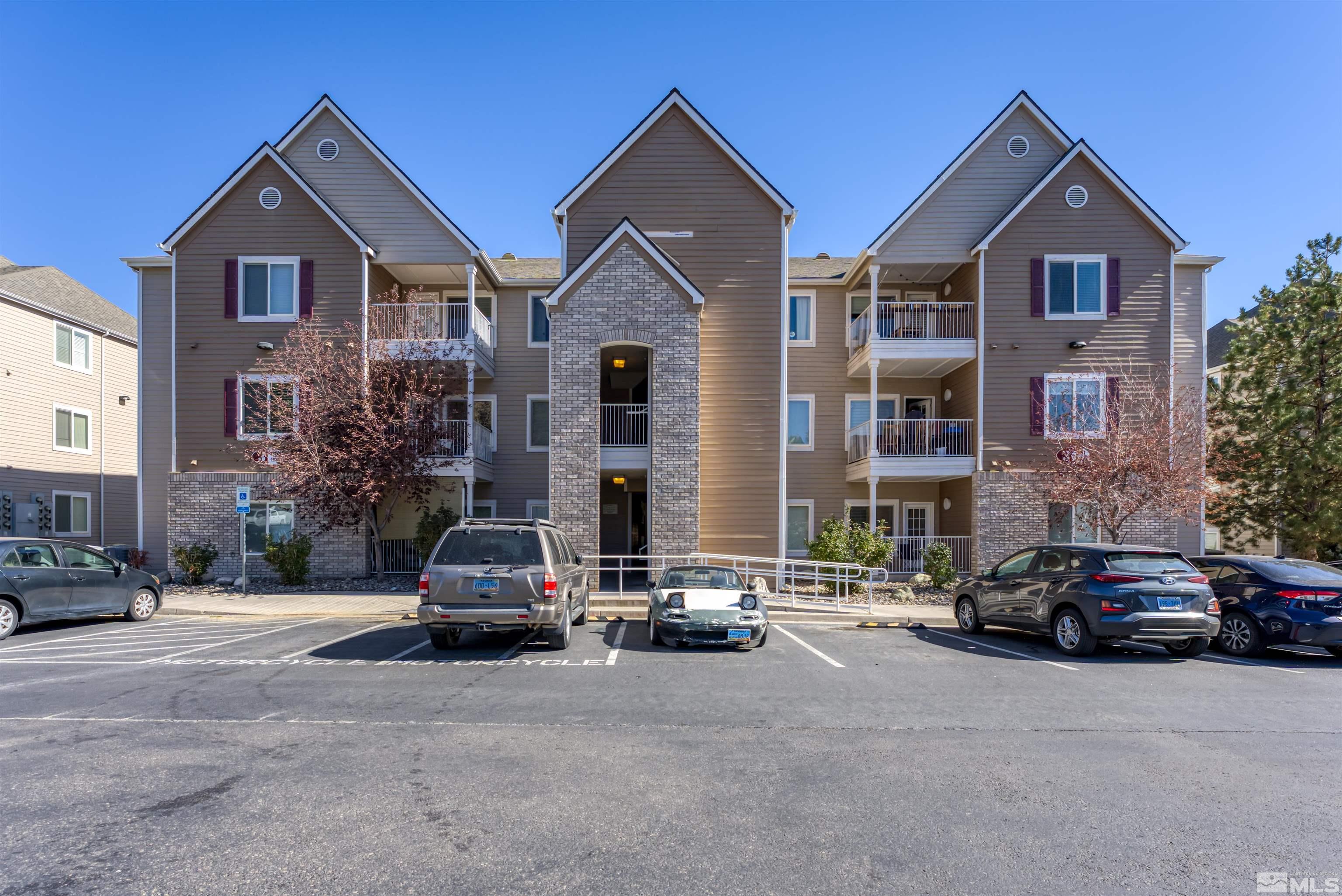 200 Talus Way, Unit 312 Reno, NV 89503 - Photo 1 of 33 a car parked in front of a brick house with a yard