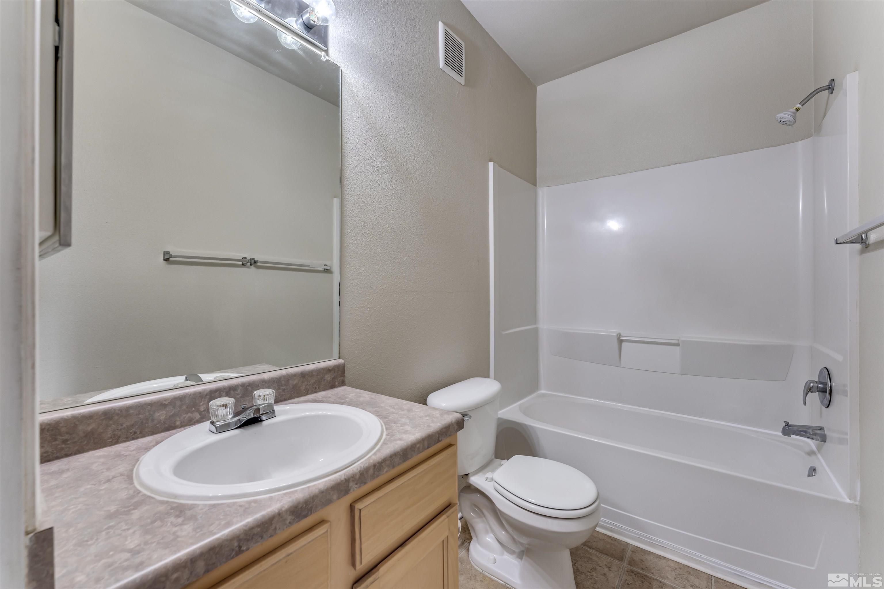 200 Talus Way, Unit 312 Reno, NV 89503 - Photo 16 of 33 a bathroom with a sink a toilet and a bathtub