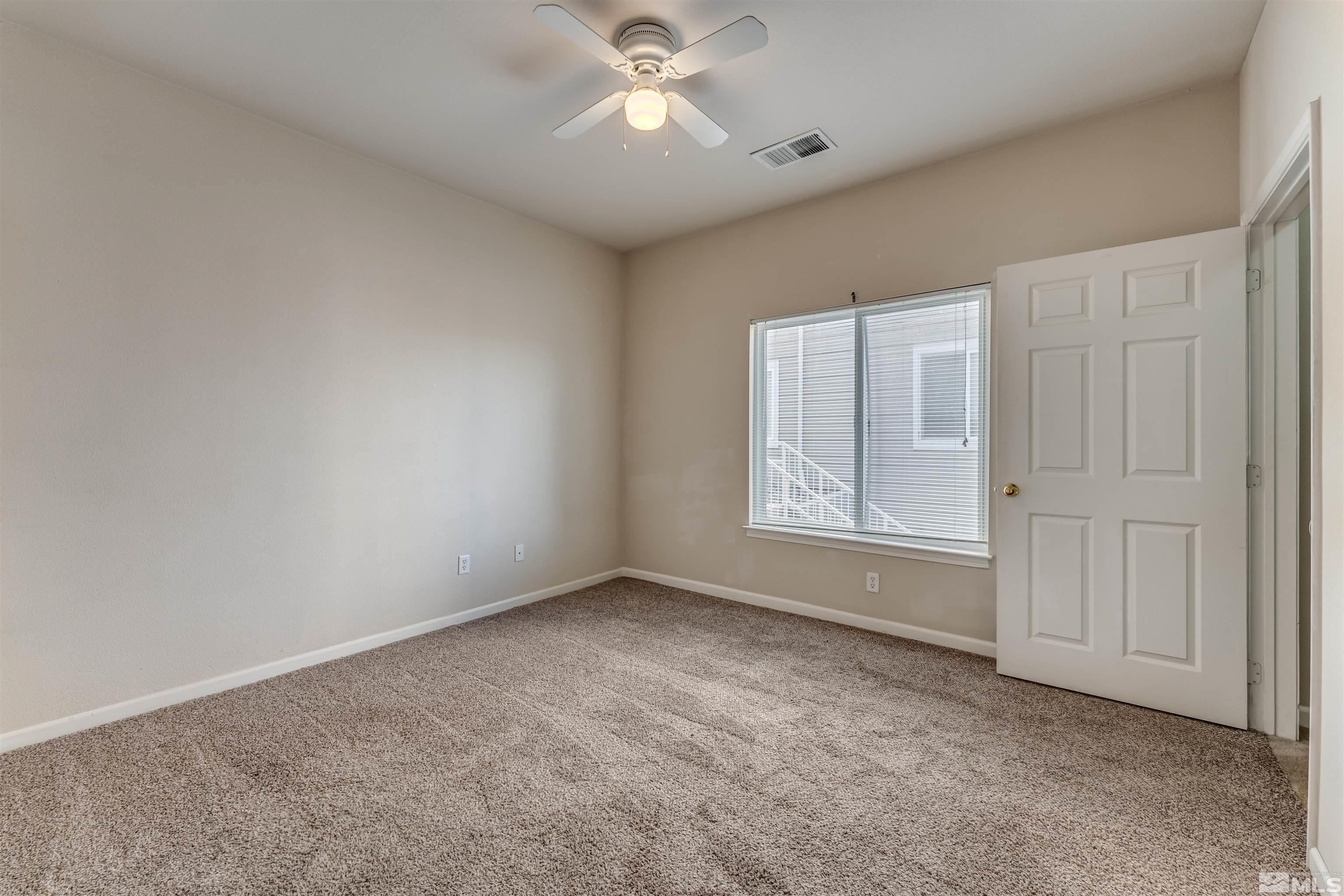 200 Talus Way, Unit 312 Reno, NV 89503 - Photo 17 of 33 an empty room with chandelier fan and windows