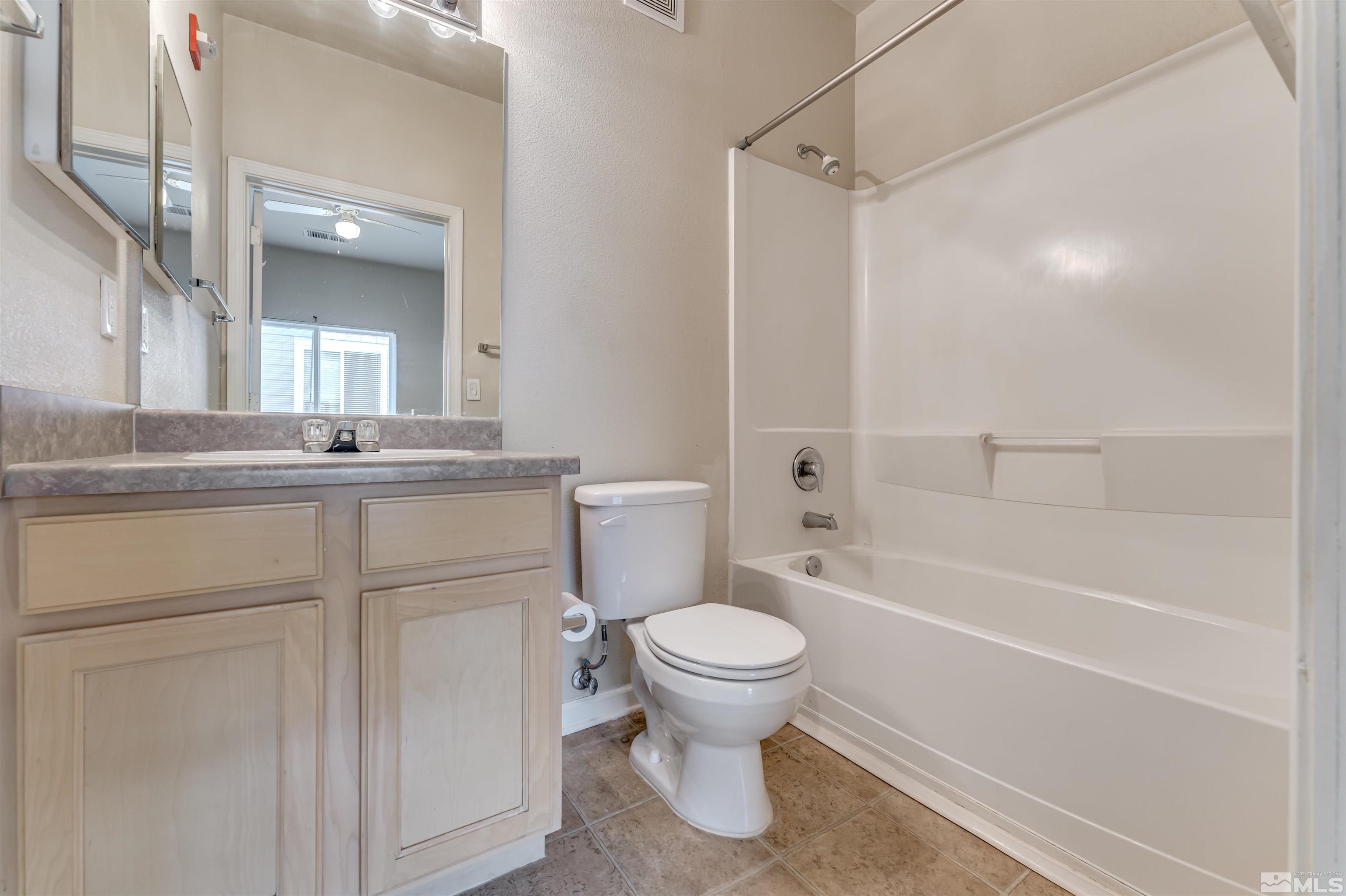 200 Talus Way, Unit 312 Reno, NV 89503 - Photo 19 of 33 a bathroom with a granite countertop sink toilet and shower