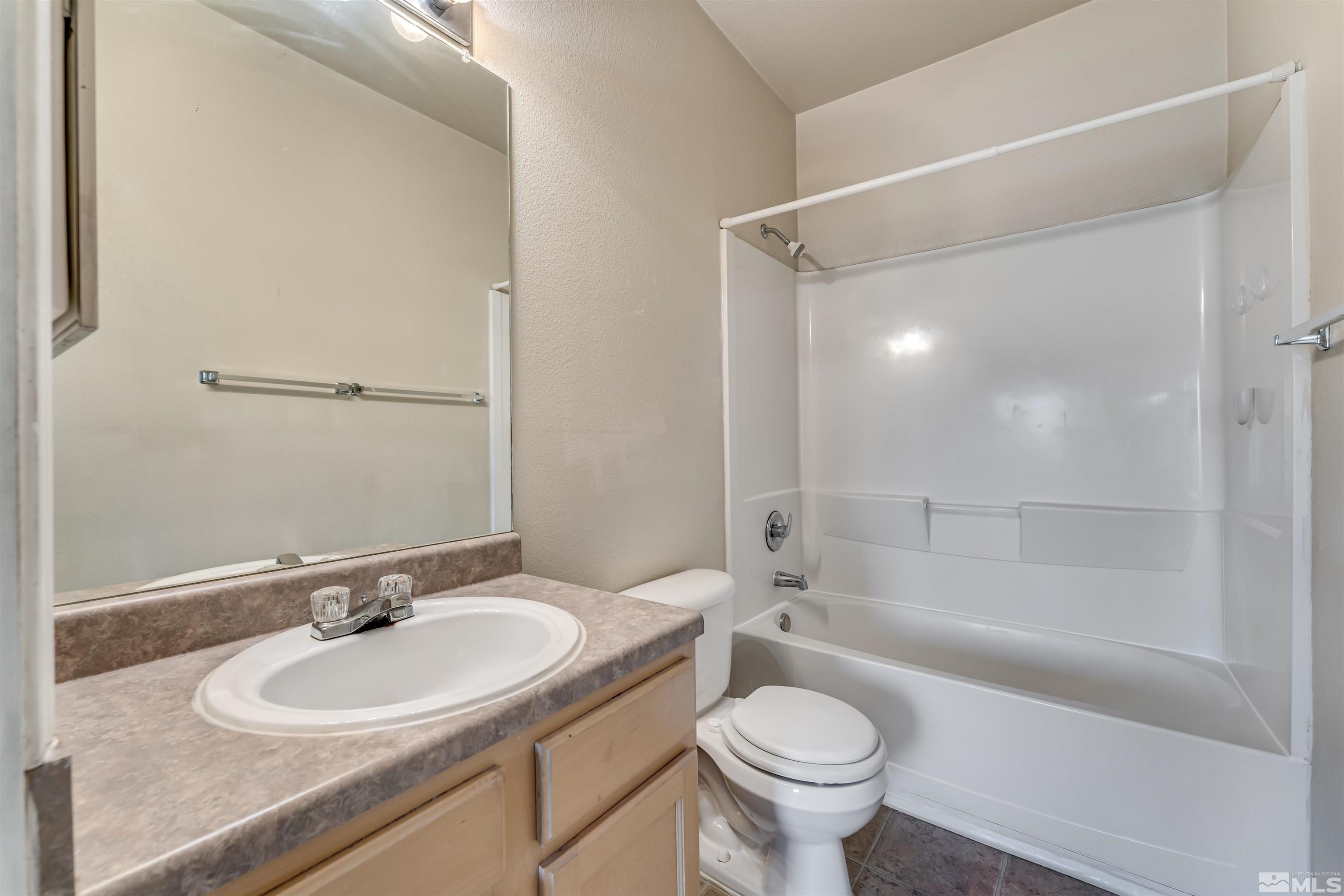 200 Talus Way, Unit 312 Reno, NV 89503 - Photo 25 of 33 a bathroom with a sink toilet mirror and shower