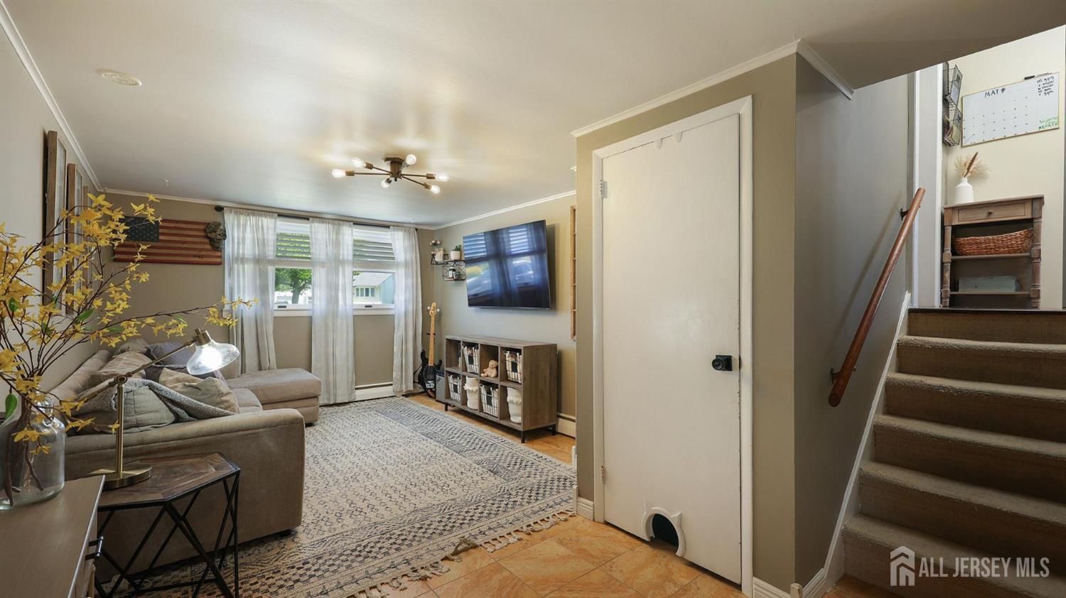 47 Miliken Road Colonia, NJ 07067 - Photo 21 of 40 a living room with furniture and a flat screen tv