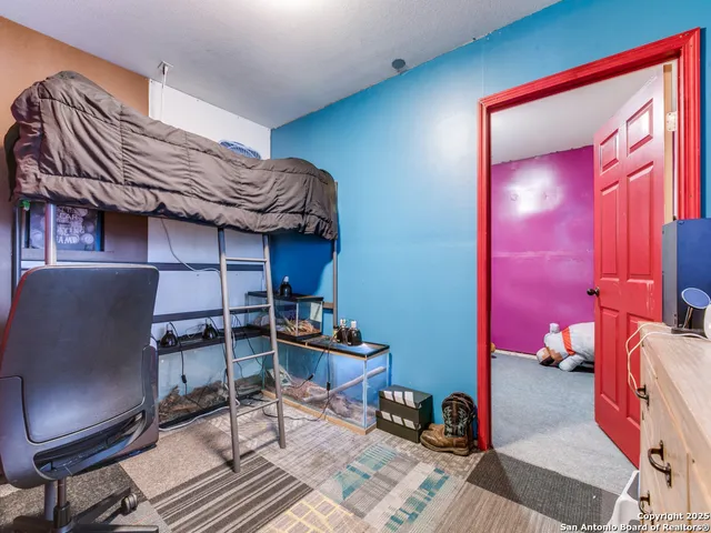 a bedroom with a bed and a mirror