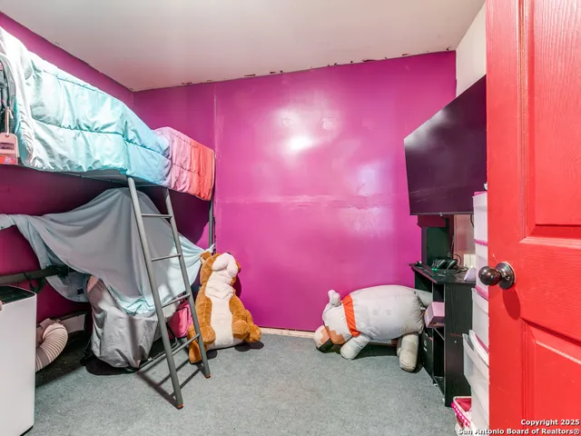 a room with pool table and chairs