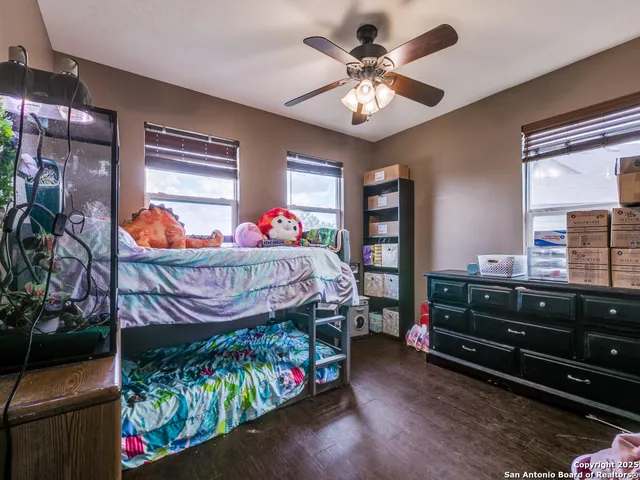a bedroom with a bed table closet and a window