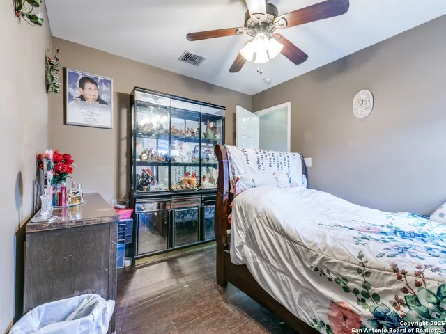 a bedroom with a bed and a chandelier