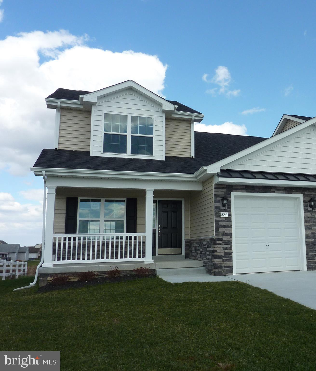 a view of a white house with a small yard and a large window