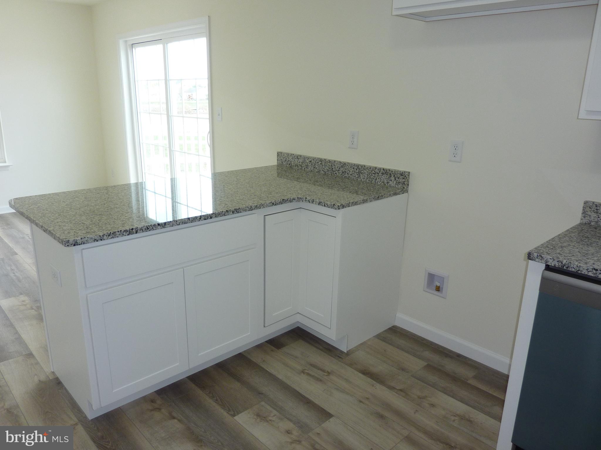 280 Doylestown Road Smyrna, DE 19977 - Photo 11 of 37 a kitchen with granite countertop white cabinets and white appliances
