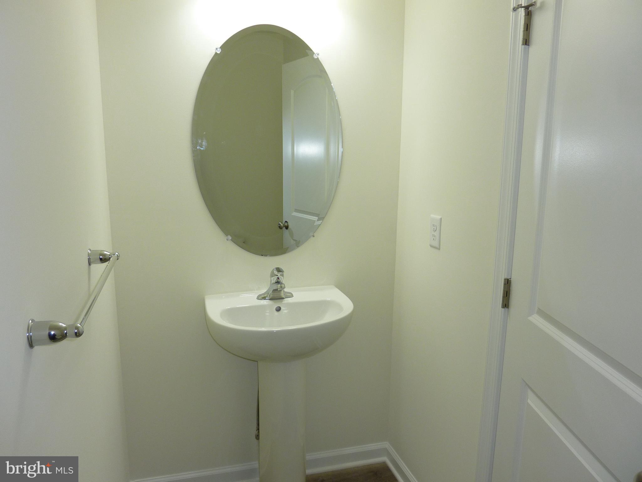 280 Doylestown Road Smyrna, DE 19977 - Photo 12 of 37 a bathroom with a sink and a mirror