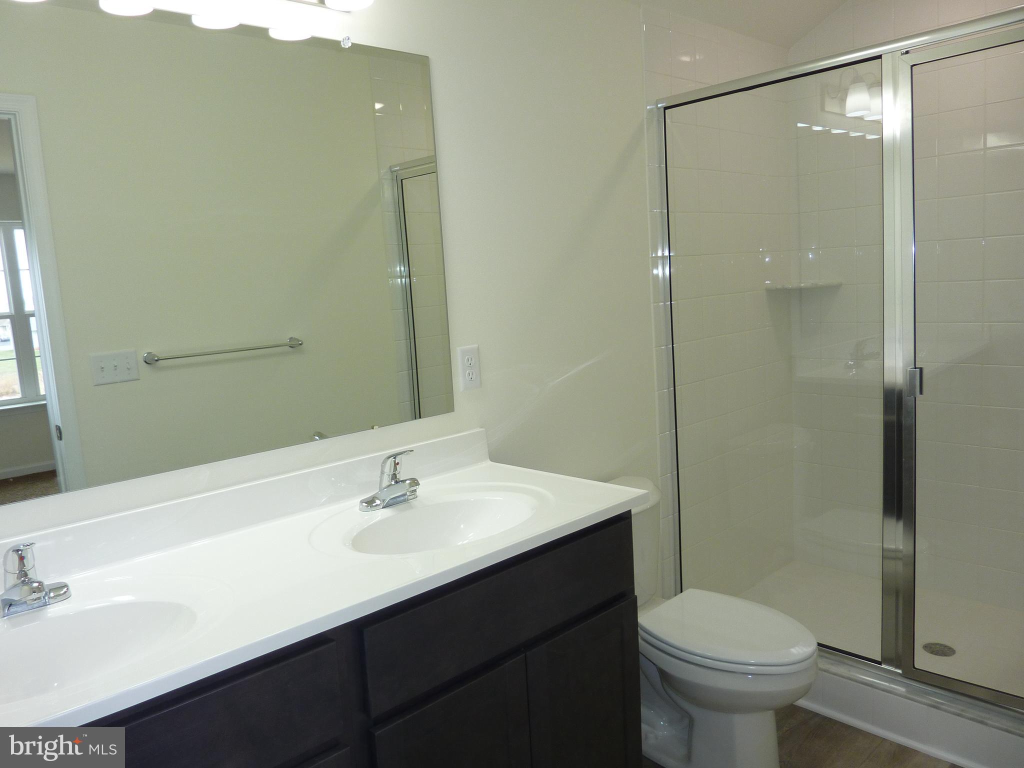280 Doylestown Road Smyrna, DE 19977 - Photo 20 of 37 a bathroom with a sink toilet and shower