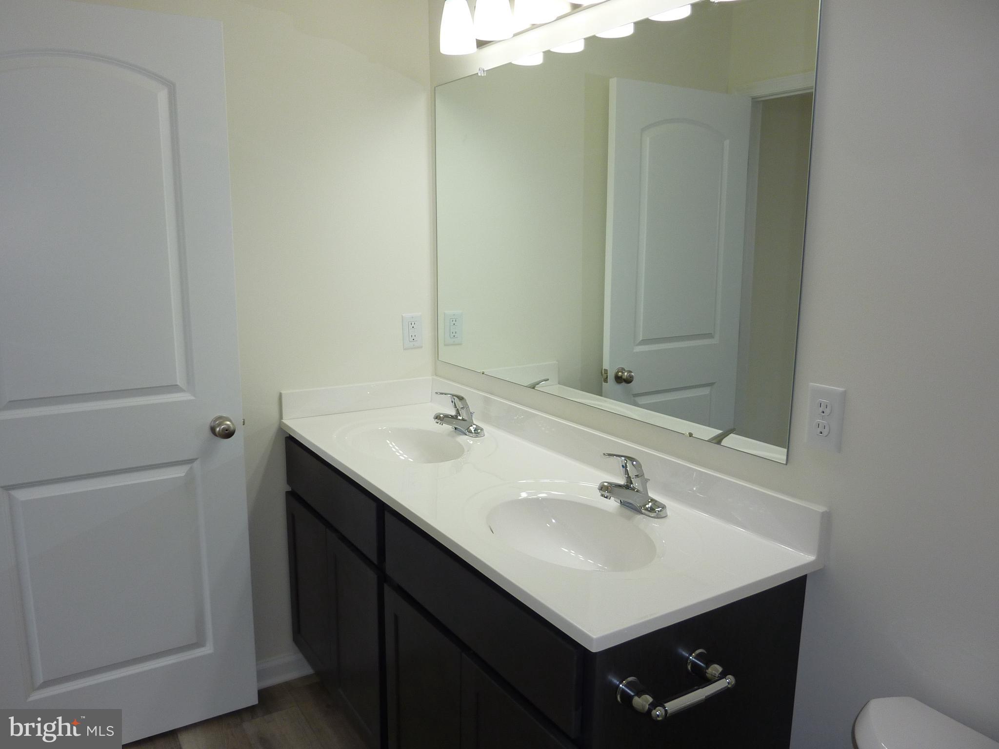 280 Doylestown Road Smyrna, DE 19977 - Photo 22 of 37 a bathroom with a sink and a mirror