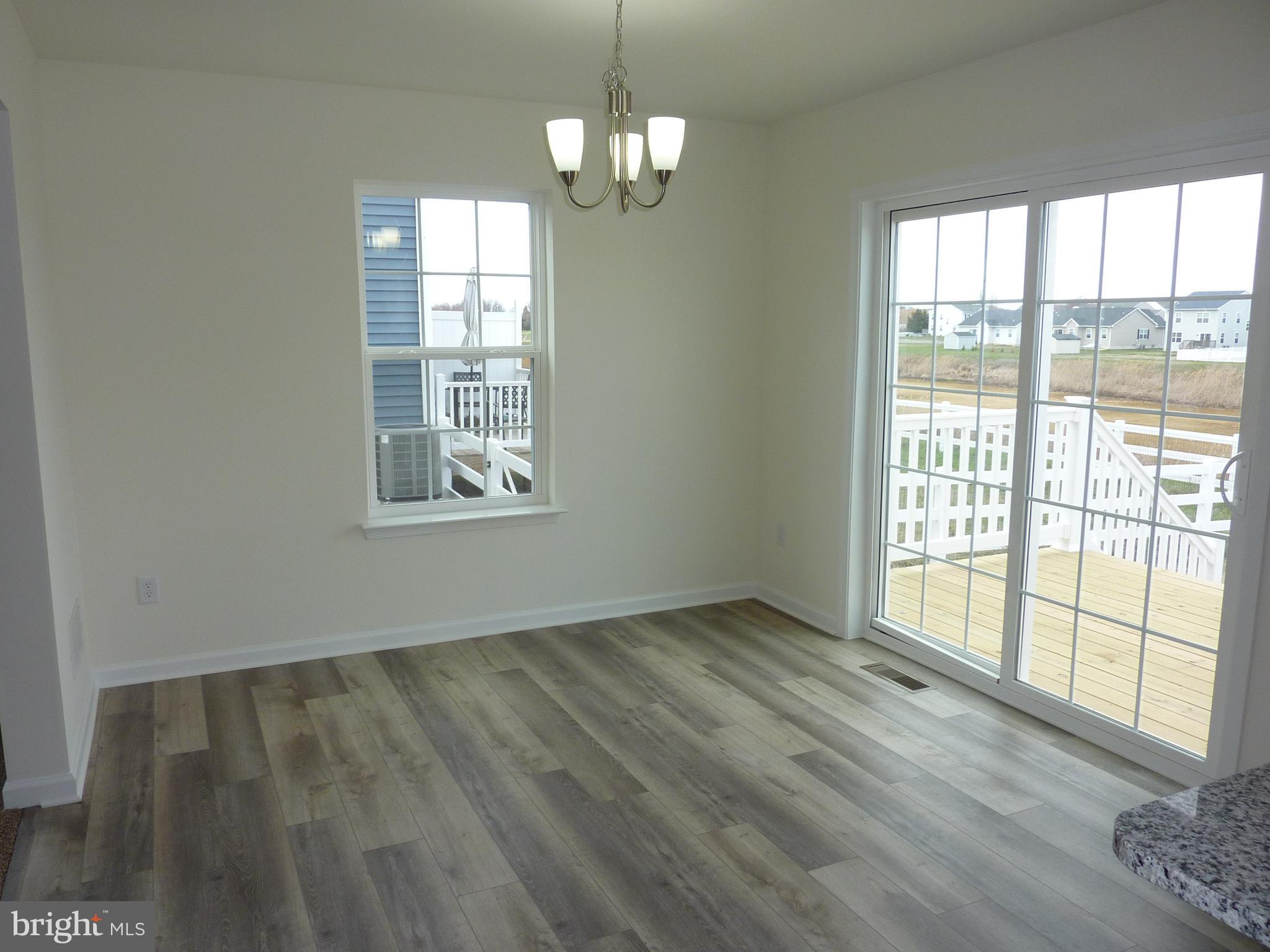 280 Doylestown Road Smyrna, DE 19977 - Photo 6 of 37 a view of an empty room with wooden floor and a window