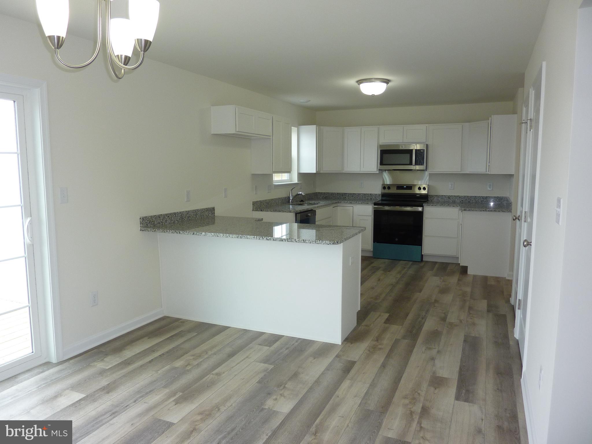 280 Doylestown Road Smyrna, DE 19977 - Photo 7 of 37 a kitchen with stainless steel appliances a refrigerator sink and stove