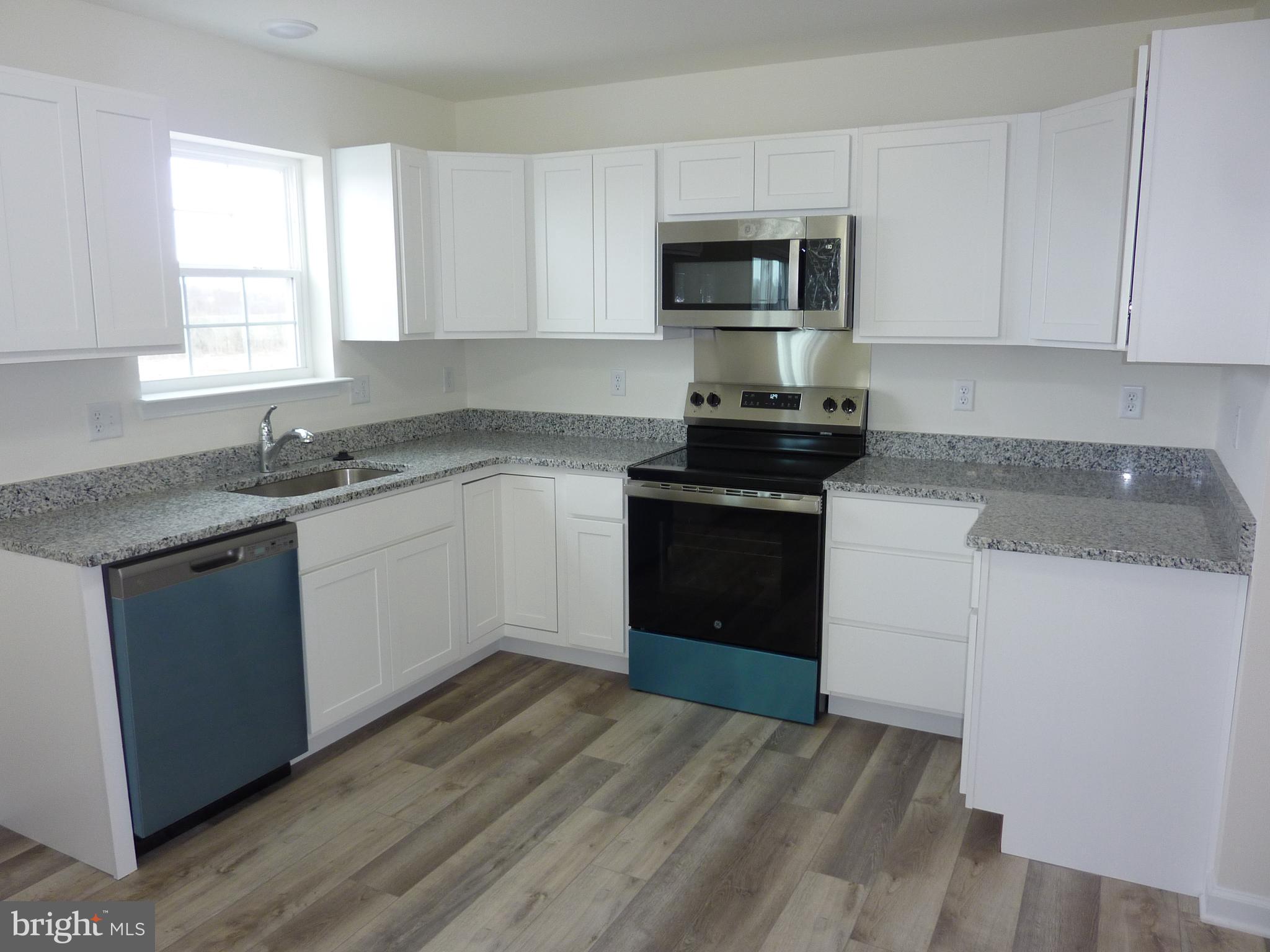 280 Doylestown Road Smyrna, DE 19977 - Photo 8 of 37 a kitchen with sink a microwave and cabinets