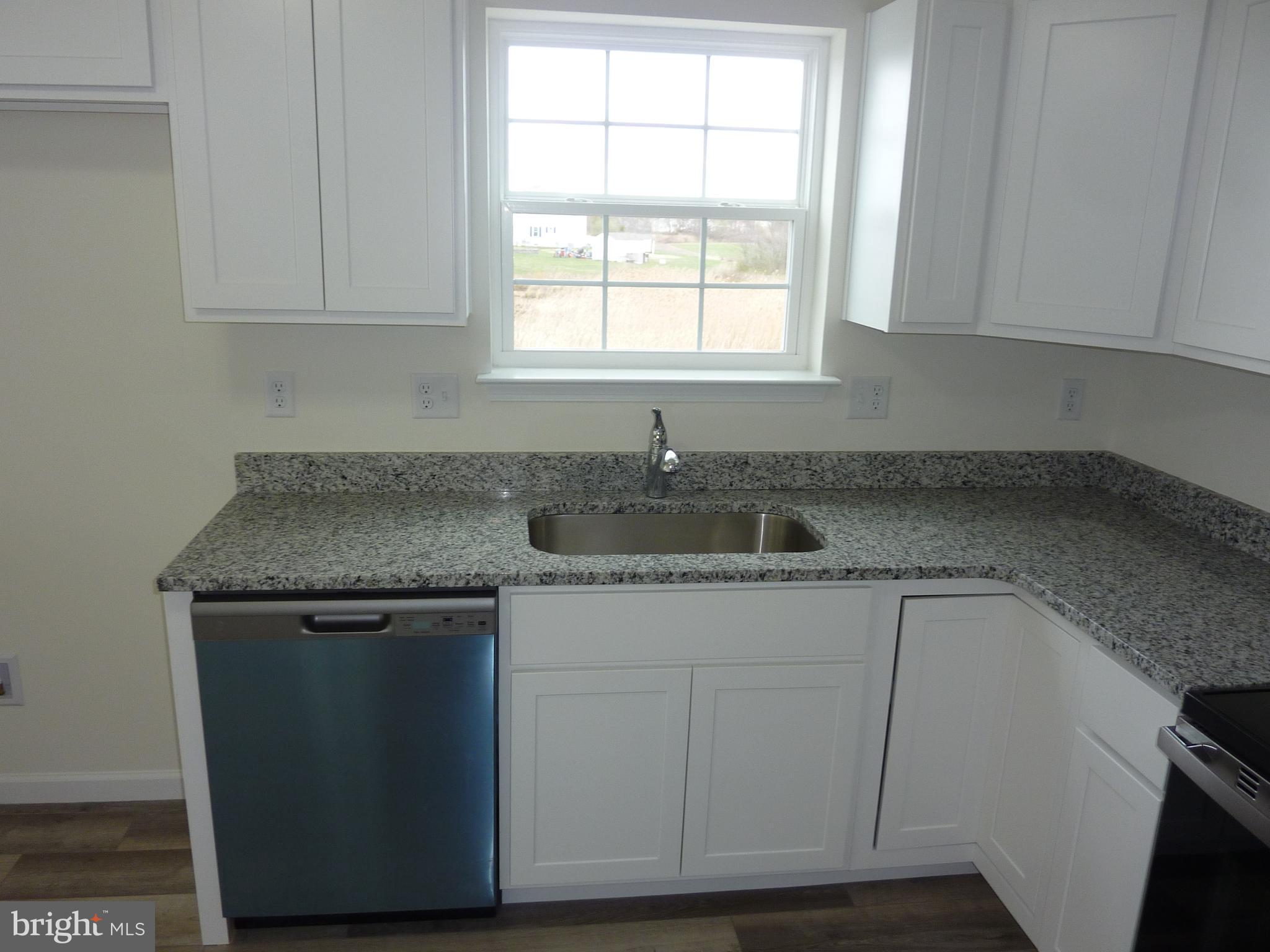 280 Doylestown Road Smyrna, DE 19977 - Photo 10 of 37 a kitchen with granite countertop cabinets sink and window