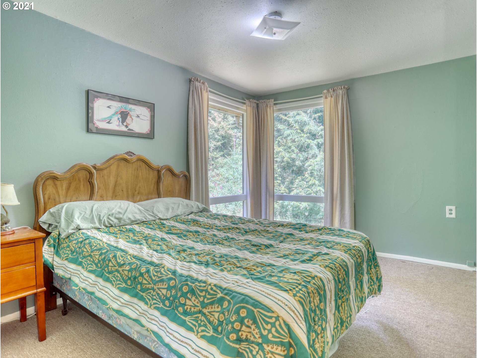 21070 Southeast Bornstedt Road Sandy, OR 97055 - Photo 11 of 31 a bedroom with a bed painting on wall and a large window