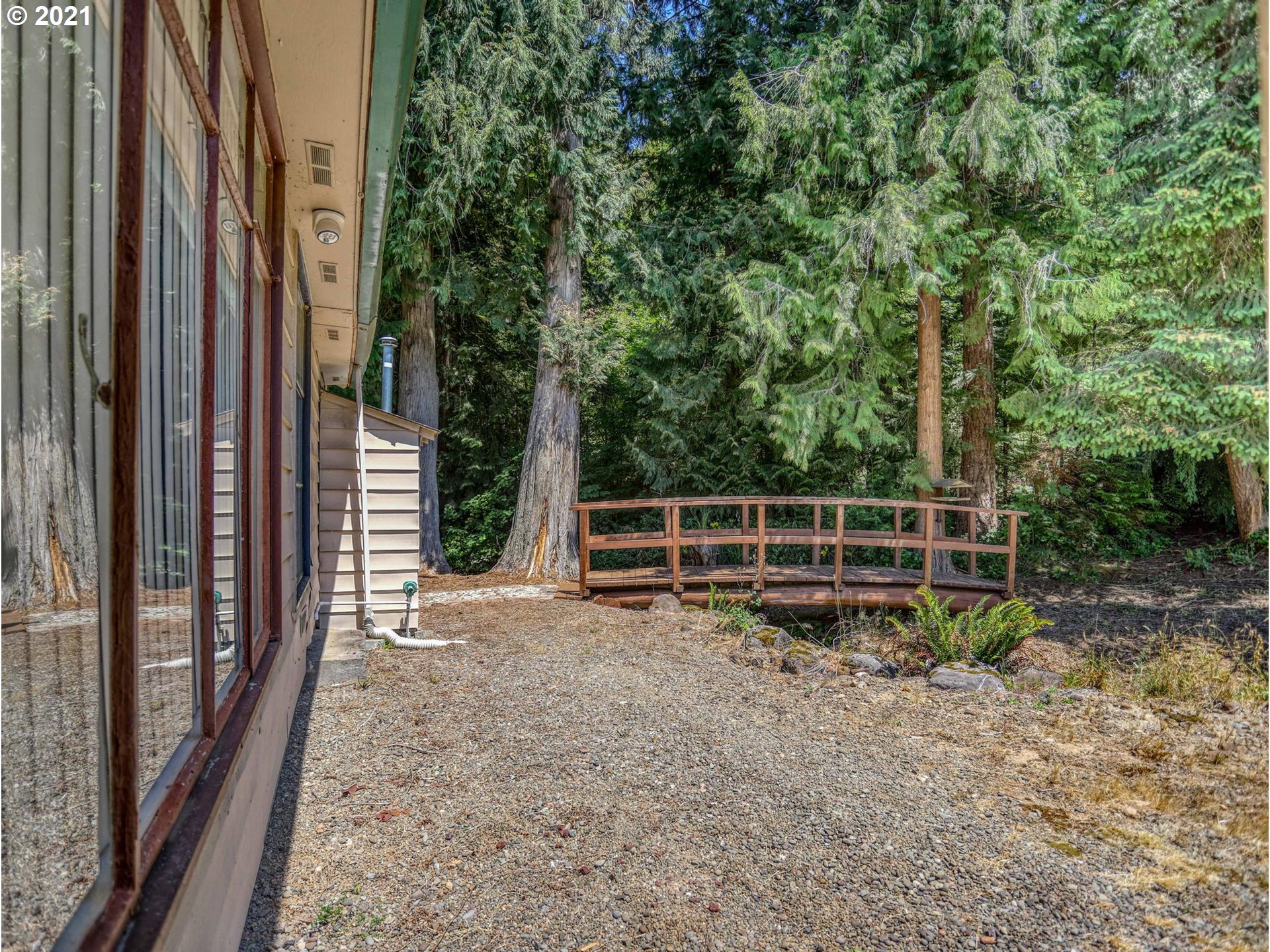 21070 Southeast Bornstedt Road Sandy, OR 97055 - Photo 19 of 31 a view of a backyard with plants and large trees