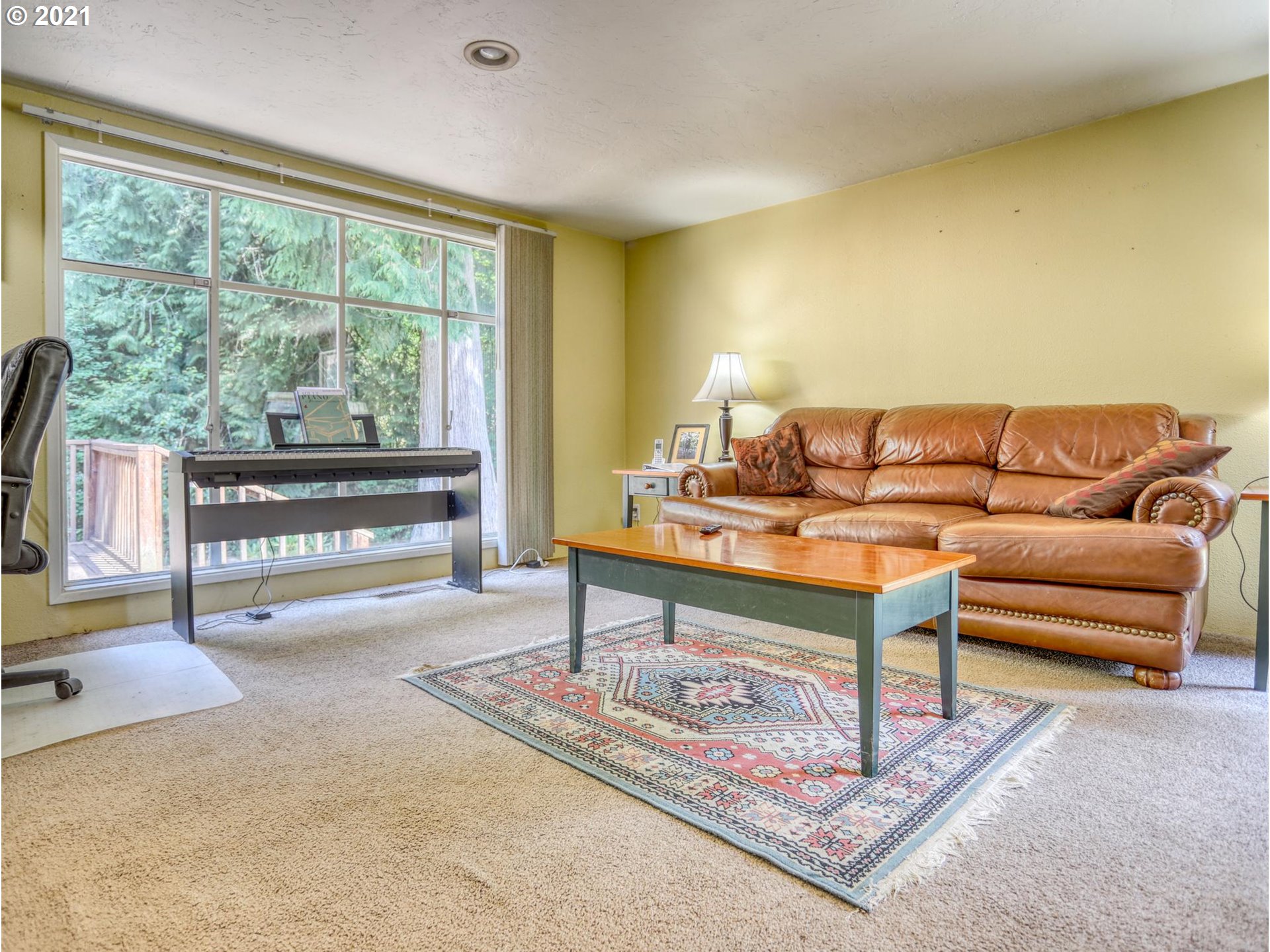 21070 Southeast Bornstedt Road Sandy, OR 97055 - Photo 3 of 31 a living room with furniture and a floor to ceiling window