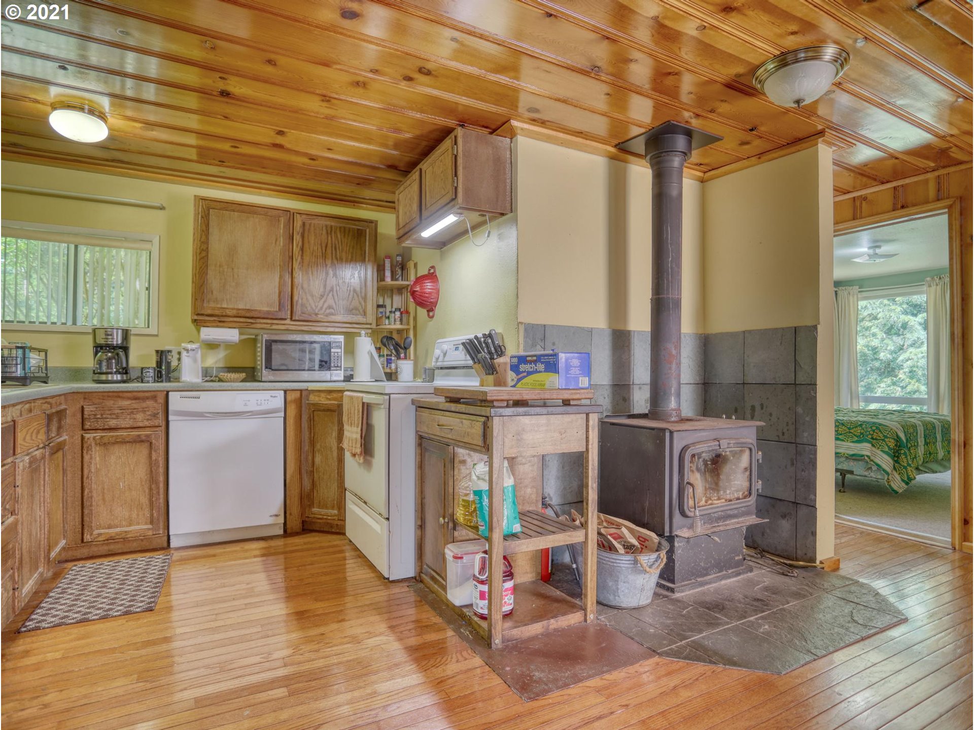 21070 Southeast Bornstedt Road Sandy, OR 97055 - Photo 5 of 31 a kitchen with stainless steel appliances granite countertop a sink a stove and a wooden floors