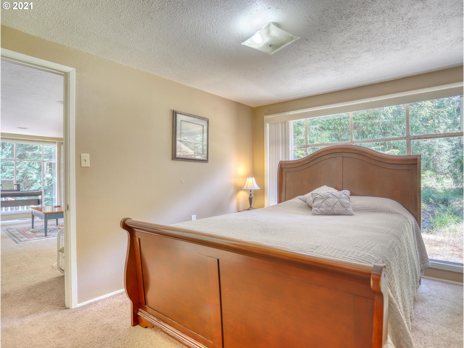 21070 Southeast Bornstedt Road Sandy, OR 97055 - Photo 9 of 31 a bedroom with a bed and a large window