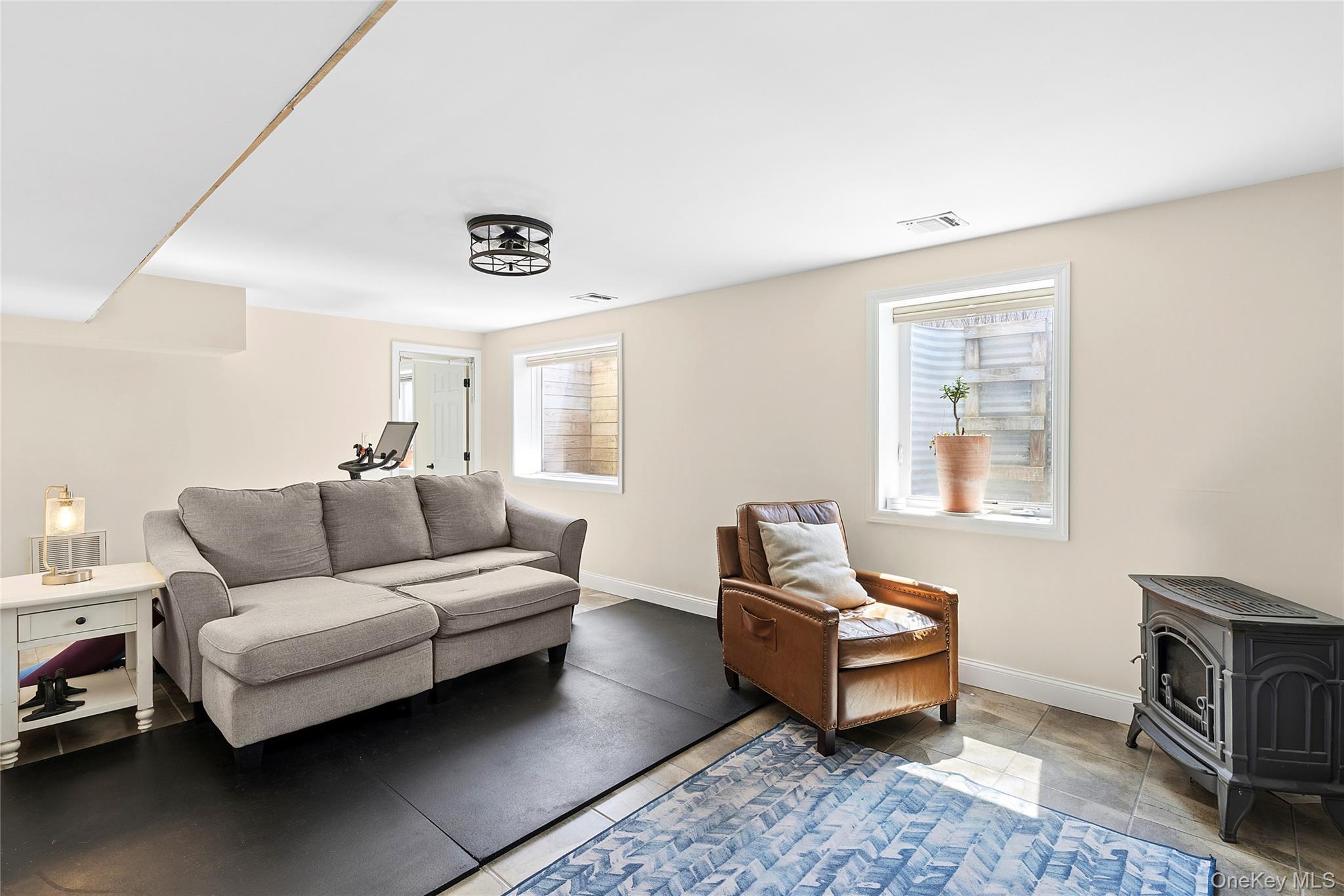 24 Woodridge Road Hampton Bays, NY 11946 - Photo 12 of 18 a living room with furniture and a window