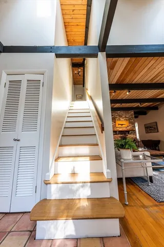 a view of entryway and hall with wooden floor