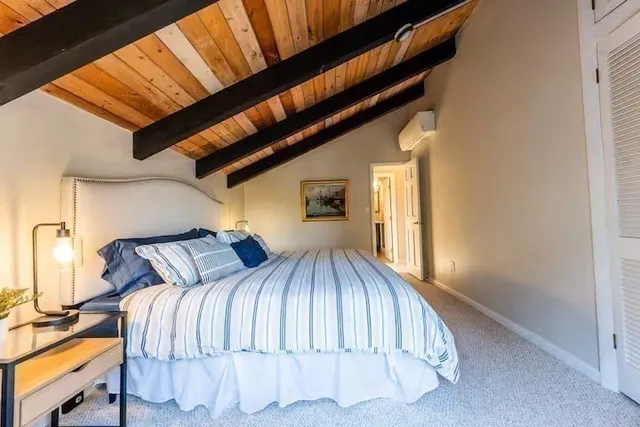 a bedroom with a bed and window