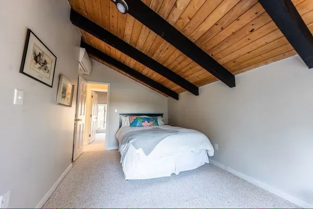 a bedroom with a bed and a wall painting