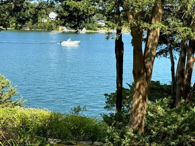 a view of a lake with a house in the background