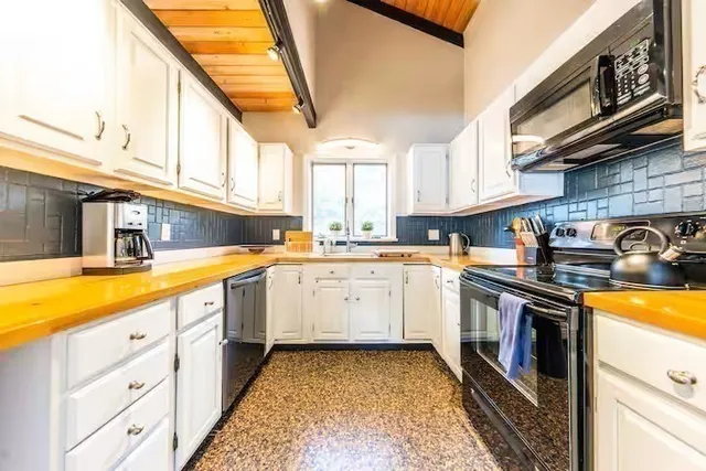 a kitchen with granite countertop a sink and cabinets