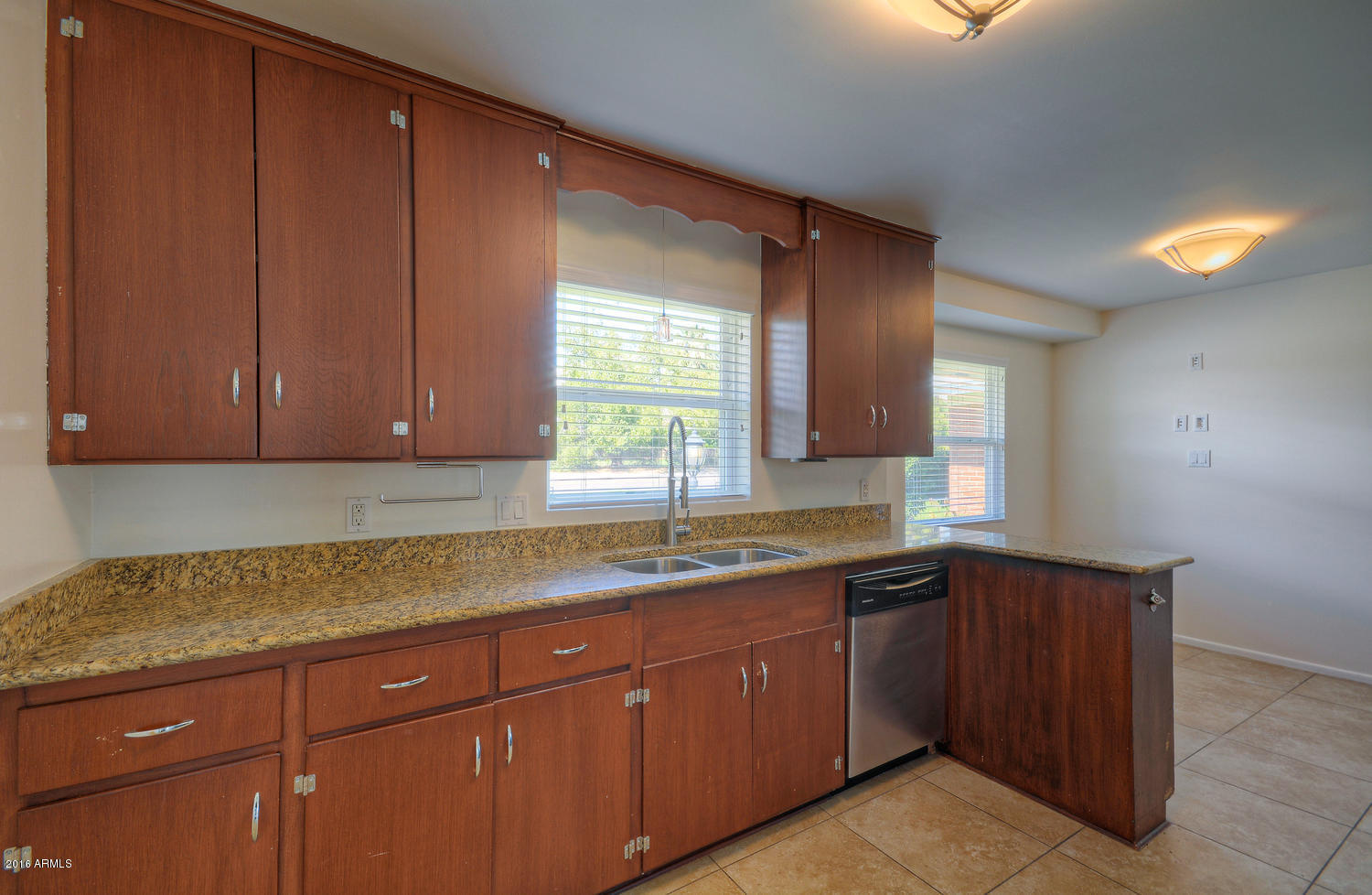 4831 East Osborn Road Phoenix, AZ 85018 - Photo 10 of 27 a kitchen with sink and cabinets