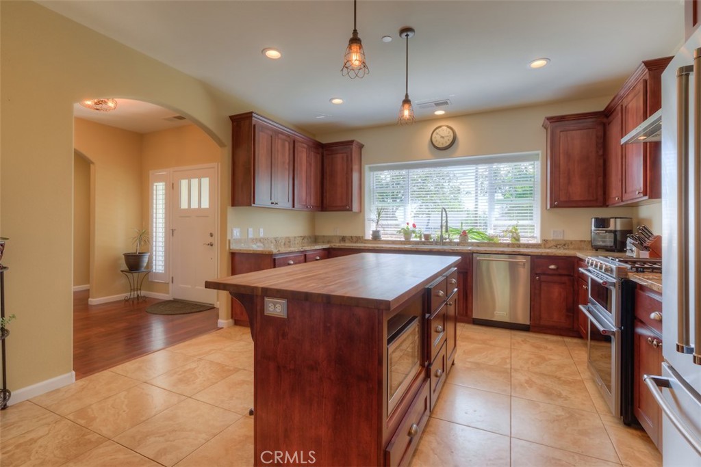95 Sutter Road Paradise, CA 95969 - Photo 11 of 47 a kitchen with a stove sink cabinets and refrigerator