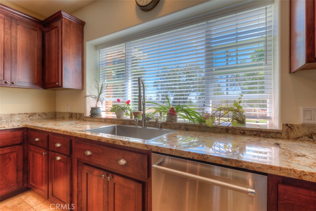 95 Sutter Road Paradise, CA 95969 - Photo 13 of 47 a kitchen with stainless steel appliances granite countertop a sink a stove and wooden cabinets