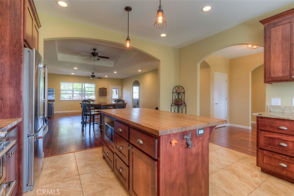 95 Sutter Road Paradise, CA 95969 - Photo 14 of 47 a dining hall with stainless steel appliances granite countertop a kitchen island a sink a stove and a refrigerator